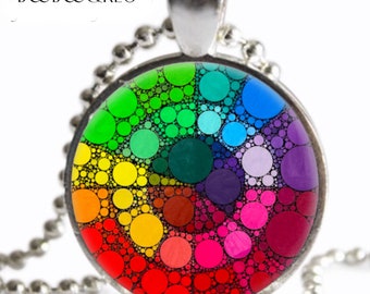 May include: A silver chain necklace with a round pendant featuring a colorful rainbow design made of circles of different sizes. The pendant is made of glass and has a black background.