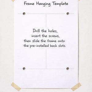 May include: A white rectangular frame hanging template paper with four circular hole markers and dashed alignment lines. The text reads: Frame Hanging Template. Drill the holes, insert the screws, then slide the frame onto the pre-installed back slots.