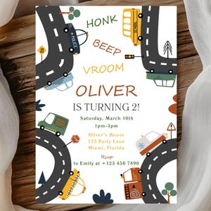 May include: A colorful birthday invitation featuring a road design with various vehicles, including a police car, school bus, and taxi. The invitation reads "OLIVER IS TURNING 2!" with event details. The design includes the words "HONK", "BEEP", and "VROOM".