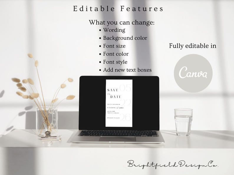 May include: A laptop displays a minimalist save-the-date card design. The screen shows a vertical layout with text and numbers. The image also includes a glass of water, a vase with dried flowers, and text that says "Editable Features" and "Fully editable in Canva."