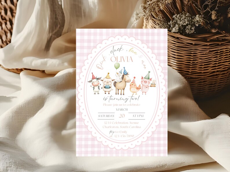 May include: A pink gingham birthday invitation with an oval frame featuring farm animals wearing party hats. The text reads "Olivia is turning two!" and includes date, time, and location details.