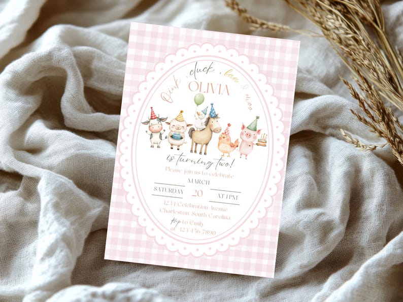 May include: A pink gingham-patterned invitation with an oval frame featuring cartoon farm animals. The text reads "Olivia is turning two!" with event details. The invitation is on a white fabric background.