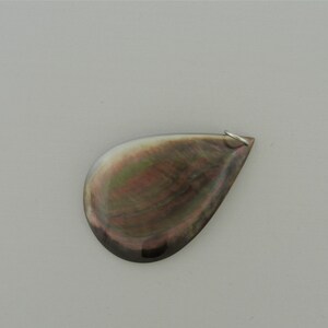 May include: A teardrop-shaped pendant made from iridescent black mother of pearl with a silver bail.