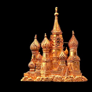 May include: A gold-colored miniature of a cathedral with multiple onion domes and spires. The detailed architectural model is set against a black background, showcasing its intricate design and metallic sheen. The overall theme is religious architecture.