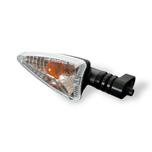 May include: A motorcycle indicator with a clear lens and an amber light. The indicator has a black stem and a mounting base. The lens is shaped like a pointed triangle.