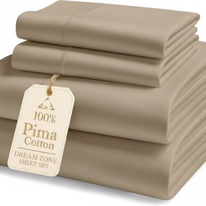 May include: A set of tan-coloured bed sheets, including a fitted sheet, flat sheet, and pillowcases. A tag reads "100% Pima Cotton DREAM ZONE SHEET SET". The sheets are neatly folded, showcasing a smooth, wrinkle-free texture.