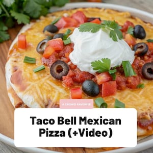 May include: A close-up of a Taco Bell Mexican Pizza, featuring a crispy base topped with melted cheese, diced tomatoes, black olives, and a dollop of sour cream. The text "A Crowd Favorite" and "Taco Bell Mexican Pizza (+Video)" are visible.