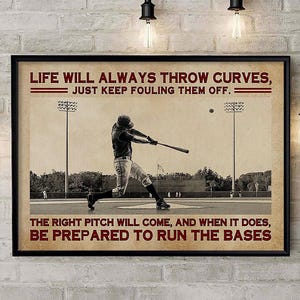 May include: A framed wall art print featuring a sepia-toned baseball player swinging a bat on a field. The text reads: LIFE WILL ALWAYS THROW CURVES, JUST KEEP FOULING THEM OFF. THE RIGHT PITCH WILL COME, AND WHEN IT DOES, BE PREPARED TO RUN THE BASES.