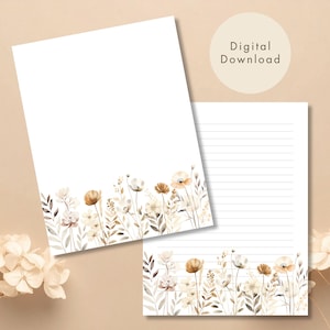May include: Two sheets of white stationery with a watercolor floral design. One sheet is blank, and the other has horizontal lines. The floral border features beige, brown, and white flowers and foliage. The words "Digital Download" are in a circle.