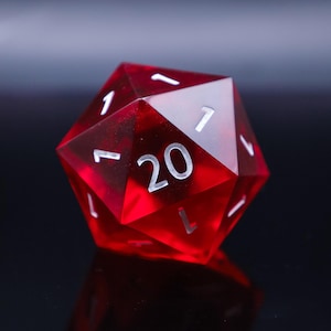 May include: A red, twenty-sided die with white numbering. The die is transparent, allowing light to pass through, and is set against a dark background. The number 20 is prominently displayed on one face.