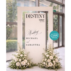 May include: A white wedding sign with the word "DESTINY" at the top, followed by "Soulmate July 2026". The word "Wedding" is written in cursive, with the names "MICHAEL and SAMANTHA" below. White flowers decorate the base of the sign.