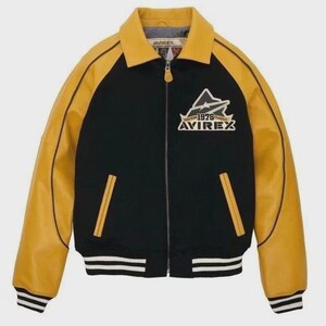 May include: Black and yellow varsity jacket featuring the text "AVIREX" and "1975 Classic". The jacket has a yellow collar and sleeves, with black panels. It has a zip closure, two front pockets, and a striped hem. The jacket is a classic design.