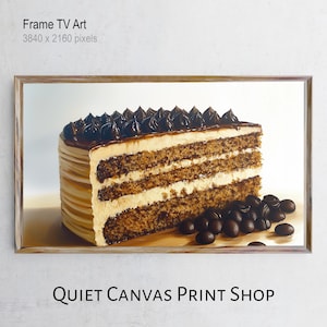 Puede incluir: Impresión enmarcada de una porción de pastel en capas con glaseado de chocolate y granos de café. El pastel tiene un exterior marrón claro y un relleno blanco cremoso. El marco es de color marrón claro. El texto "Frame TV Art" y "QUIET CANVAS PRINT SHOP" son visibles.