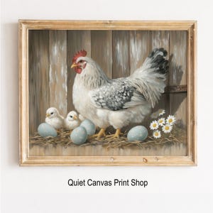 May include: A framed print of a hen with three chicks and several blue eggs in a nest. The hen is white with gray markings and a red comb. The background is a wooden fence. The print is from Quiet Canvas Print Shop.