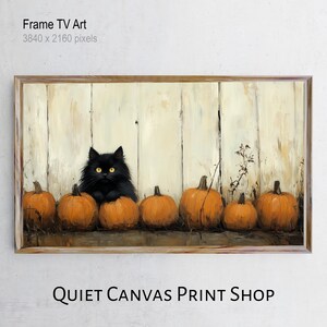 May include: A framed print featuring a black cat with yellow eyes nestled among orange pumpkins. The background is a weathered white wooden fence. The text "Frame TV Art" and "QUIET CANVAS PRINT SHOP" are visible.