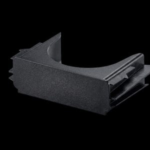 May include: A black plastic car cup holder with a textured surface. The holder has a curved opening and a rectangular base with angled supports. The background is solid black.