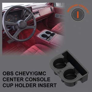 May include: A black plastic centre console cup holder insert for OBS Chevy and GMC vehicles. The insert features two circular cup slots and a rectangular storage compartment. It is shown both as a standalone product and installed in a red interior.
