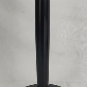 May include: A black wooden display stand featuring a circular base, a central vertical post, and a flat circular top platform. The stand has a smooth, matte finish and is designed to hold items securely in an upright position for display.