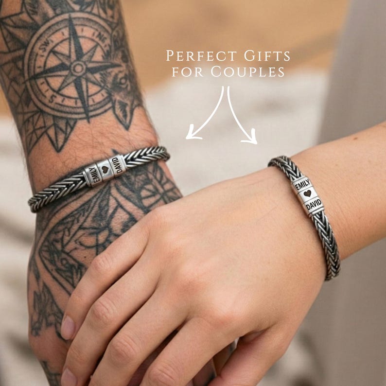 May include: Two silver braided bracelets, each with a personalized name tag. One bracelet reads "EMILY" and "DAVID" with a heart symbol. The other bracelet also has names. The image includes the text "PERFECT GIFTS FOR COUPLES".
