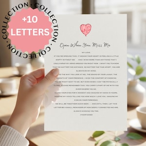 May include: A hand holding a white card with the text "Open When You Miss Me" and a pink heart illustration. The card is part of a "Collection" of +10 letters. The text on the card expresses feelings of love and longing.