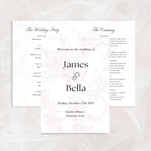 May include: Wedding stationery set featuring a floral design in soft pink. The invitation includes the names "James & Bella" and the date "Friday, October 17th 2025". The set also includes a program with ceremony details.
