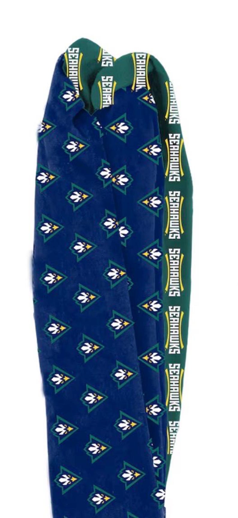 May include: A pair of blue socks with a repeating pattern of white and green floral designs. The top band is green with the word "SEAHAWKS" in white. These socks are likely for a sports fan.