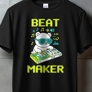 May include: Black t-shirt with a graphic of a white bear wearing sunglasses and operating a music production device. The words "BEAT MAKER" are in pixelated yellow and green font. Musical notes and sound wave icons are also present.