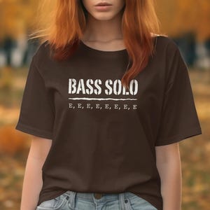 Brown t-shirt with white text "BASS SOLO" and "E, E, E, E, E, E, E, E".