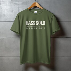 Olive green t-shirt with white "BASS SOLO" text and "E, E, E..." below.