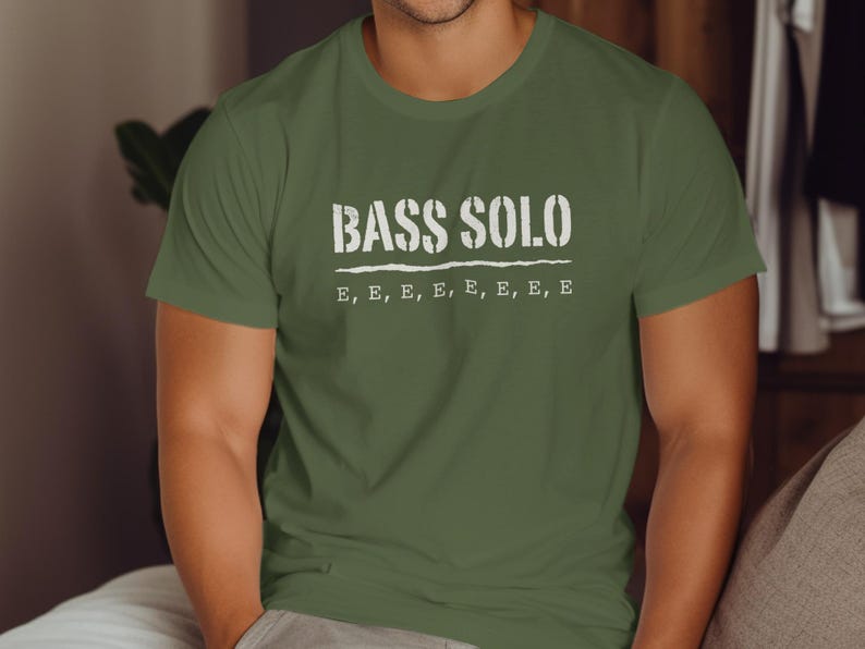 Olive green t-shirt with text "BASS SOLO" and repeated "E"s.