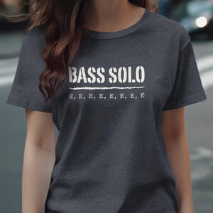 Dark gray t-shirt with white stencil text "BASS SOLO" and "E, E, E, E, E, E, E".