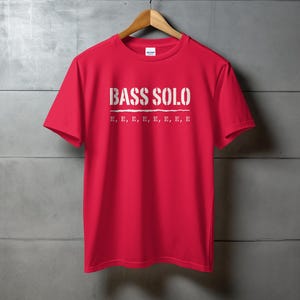 Red t-shirt with "BASS SOLO" and multiple "E"s printed on the chest.