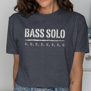 Dark grey t-shirt with "BASS SOLO" and repeated "E"s printed on the front.