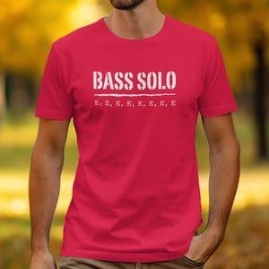 Red t-shirt with white text "BASS SOLO" and "E, E, E, E, E, E, E, E".