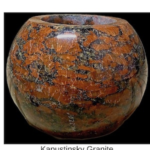 May include: A rounded, polished Kapustinsky Granite bowl with a wide opening. The stone features a mix of reddish-brown, black, and green hues, creating a marbled effect. The text "Kapustinsky Granite" is displayed below the bowl.