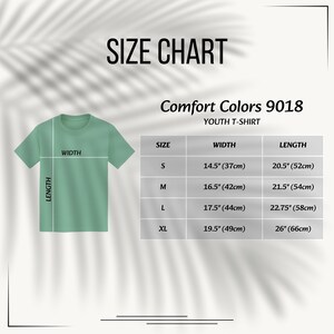May include: A size chart for a Comfort Colors 9018 youth t-shirt. The graphic shows a light green t-shirt with width and length lines, alongside a table listing sizes S, M, L, and XL with corresponding measurements in inches from 14.5 to 26 inches.