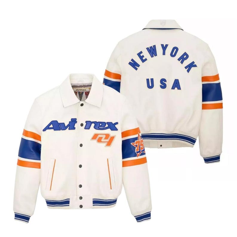 May include: White jacket with blue and orange accents. The jacket features the text "Avi-rex" on the front and "NEW YORK USA" on the back. The sleeves have blue and orange stripes, and the jacket has a button-up front.