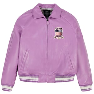 May include: A lavender leather jacket with a classic bomber style. Features a collared neckline, a zipper closure, and a patch on the chest with a shield design. The cuffs and hem have white and purple striped detailing.