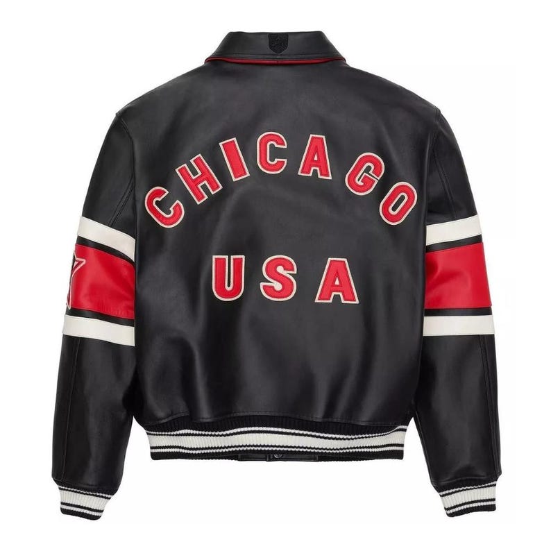 May include: Black leather jacket with the word "CHICAGO" arched across the back in red lettering with a white outline, above "USA". The sleeves have red and white stripes. The jacket has a white and black striped hem.