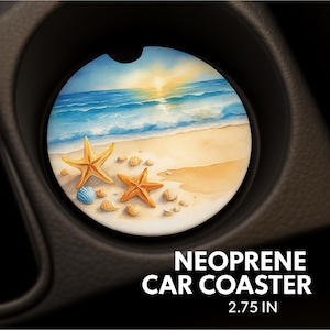 May include: A round neoprene car coaster featuring a beach scene with a sunset, ocean waves, and sand. Two starfish and seashells are on the sand. The coaster is 2.75 inches in diameter.