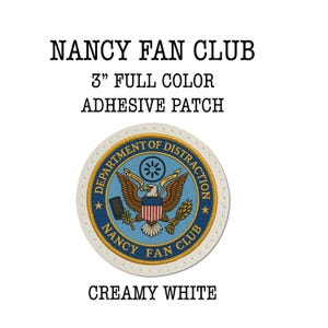 May include: Creamy white 3-inch full-color adhesive patch. The patch features a circular design with a blue and gold emblem, an eagle, and the text "NANCY FAN CLUB" and "DEPARTMENT OF DISTRACTION".