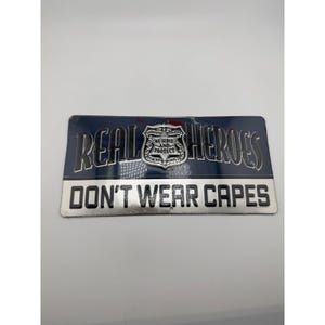 Open Road Brands Real Heroes Don't Wear Capes Police Metal Sign 12x6 New image 1