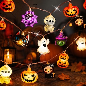 Peut inclure: Une guirlande lumineuse LED d'Halloween composée de diverses figurines éclairées, dont des citrouilles orange, une toile d'araignée violette, une momie blanche, un visage de chat noir, un fantôme blanc, une sorcière verte et un crâne noir.