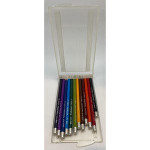 May include: A clear plastic pencil case with a hinged lid, containing a set of colored pencils. The pencils are arranged in a row, with a variety of colors visible, including purple, blue, green, and red. The pencils have silver metal bands and erasers.