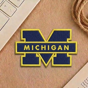 May include: A white ceramic mug with a black handle and the text "But First, Coffee" in a handwritten style. The mug is on a white surface. The mug is approximately 4 inches tall.