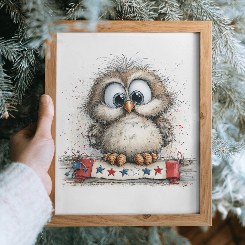 May include: A framed watercolour print of a cartoon owl with large blue eyes. The owl is perched on a banner with red, white, and blue stars. The frame is made of light brown wood.