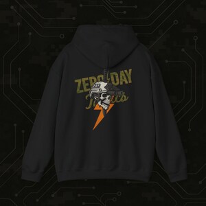 May include: Black hooded sweatshirt with a graphic on the back. The graphic features a skull wearing a helmet and night vision goggles, with the text "Zero Day Tactics" and a lightning bolt.