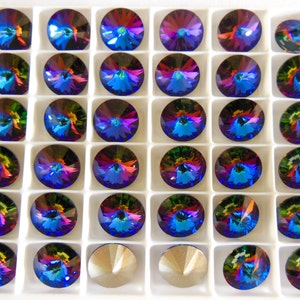 May include: A tray of 48 iridescent blue, green, and red round rhinestones in a white plastic tray.