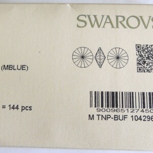 May include: A package of 144 Swarovski crystal rhinestones in Meridian Blue, size 1122 (12 mm). The package includes a barcode, a QR code, and the text "5127450 1/00/00 gross = 144 pcs 9009651274502 M TNP-BUF 104296759".