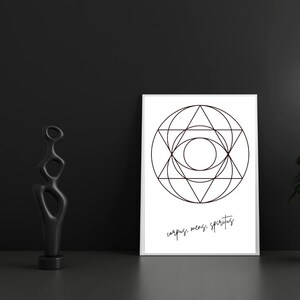 May include: A framed white print with a geometric design in black lines, featuring circles, triangles, and a central eye-like shape. The text "corpus, mens, spiritus" is below the design. A black abstract sculpture stands to the left.